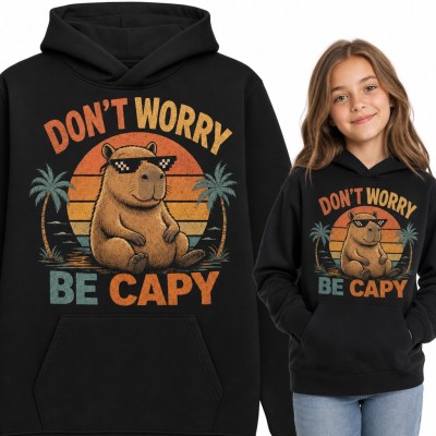 Bluza dziewczęca z kapturem „Don't worry be capy” - kapibara w okularach na tle retro zachodu